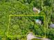 Aerial perspective outlining the property's boundaries, surrounded by dense trees and neighboring homes at 7401 Heartland Dr, Wake Forest, NC 27587