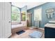 A bright bathroom featuring a soaking tub beneath a large arched window and a glass-enclosed shower at 7401 Heartland Dr, Wake Forest, NC 27587