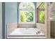 Bright bathroom featuring a large soaking tub by a window, with a glass-enclosed shower at 7401 Heartland Dr, Wake Forest, NC 27587