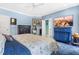 Bright bedroom features a TV, furnishings, and is painted a tranquil light blue at 7401 Heartland Dr, Wake Forest, NC 27587