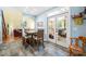 Dining area with table, chairs, tile floors and open to screened porch through glass doors at 7401 Heartland Dr, Wake Forest, NC 27587