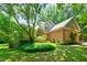 Attractive brick home with lush green lawn and mature landscaping creating a welcoming entrance at 7401 Heartland Dr, Wake Forest, NC 27587