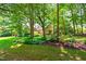 Charming brick home with mature trees, green lawn, and meticulous landscaping creates an idyllic setting at 7401 Heartland Dr, Wake Forest, NC 27587