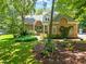 Charming brick home with a beautifully landscaped front yard featuring lush greenery and flowering plants at 7401 Heartland Dr, Wake Forest, NC 27587