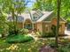 A beautiful brick home with a well-maintained landscaped yard featuring a variety of greenery and plants at 7401 Heartland Dr, Wake Forest, NC 27587