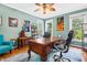Inviting home office with a large wooden desk, chair, and natural light streaming through the windows at 7401 Heartland Dr, Wake Forest, NC 27587