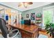 Spacious home office with beautiful natural lighting and an executive wooden desk at 7401 Heartland Dr, Wake Forest, NC 27587