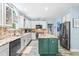 Bright kitchen featuring white cabinets, granite countertops, and a central island for meal preparation at 7401 Heartland Dr, Wake Forest, NC 27587