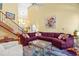 Open-concept living room with a high ceiling, a staircase, and a large sectional sofa at 7401 Heartland Dr, Wake Forest, NC 27587