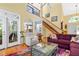 Open living room with hardwood floors, high ceilings, and staircase at 7401 Heartland Dr, Wake Forest, NC 27587