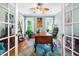 Inviting home office with wooden desk, comfortable chair, and natural light from bright windows at 7401 Heartland Dr, Wake Forest, NC 27587