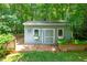 Quaint outbuilding on a lush green lawn with window boxes and a small wood deck at 7401 Heartland Dr, Wake Forest, NC 27587