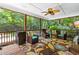 Relaxing screened porch with comfortable seating, ceiling fan, and lush greenery at 7401 Heartland Dr, Wake Forest, NC 27587