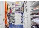 Organized walk-in closet with built-in shelving, hanging rods, and ample space for clothes and shoes at 7401 Heartland Dr, Wake Forest, NC 27587