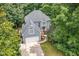 Stunning aerial view of a two-story home surrounded by lush greenery and mature trees at 7605 Sandy Lake Ct, Raleigh, NC 27613
