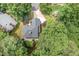 Captivating aerial view of a home featuring a dark roof, surrounded by green trees, and a well-maintained lawn at 7605 Sandy Lake Ct, Raleigh, NC 27613