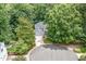 Stunning aerial view of a two-story home surrounded by lush greenery and mature trees on a cul-de-sac at 7605 Sandy Lake Ct, Raleigh, NC 27613
