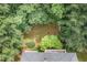 Aerial view of a home nestled among lush green trees with a glimpse of the roof and backyard at 7605 Sandy Lake Ct, Raleigh, NC 27613