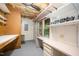 Well-lit basement workshop featuring pegboard walls, shelving, and a built-in desk for various projects at 7605 Sandy Lake Ct, Raleigh, NC 27613
