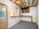 Unfinished basement with built-in shelves and workbench provides potential for customization at 7605 Sandy Lake Ct, Raleigh, NC 27613