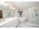 Modern bathroom with double vanity, free standing tub, and tiled shower at 7605 Sandy Lake Ct, Raleigh, NC 27613