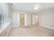 Bedroom with neutral carpet, a ceiling fan, and doorways to the bathrooms and closets at 7605 Sandy Lake Ct, Raleigh, NC 27613