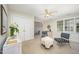 Bright bedroom featuring a ceiling fan, a dresser, and blue pattern chairs at 7605 Sandy Lake Ct, Raleigh, NC 27613
