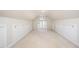 Large bonus room featuring built-in storage with an arched window, perfect for a playroom at 7605 Sandy Lake Ct, Raleigh, NC 27613