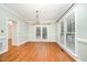 Bright dining room with hardwood floors, chandelier, and large windows at 7605 Sandy Lake Ct, Raleigh, NC 27613