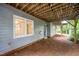 Exterior of the house showcasing the backyard with exposed ceiling and an entrance, creating an outdoor retreat at 7605 Sandy Lake Ct, Raleigh, NC 27613