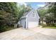 Side view of a two-story home with a two-car garage and stairs to the second story at 7605 Sandy Lake Ct, Raleigh, NC 27613