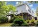 Back of the house showcasing the multi-level deck with a picturesque treed setting at 7605 Sandy Lake Ct, Raleigh, NC 27613