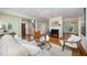 Open living room featuring a fireplace, hardwood floors, and stairs to the second floor at 7605 Sandy Lake Ct, Raleigh, NC 27613
