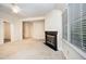Bright living room with a fireplace and large windows, offering a comfortable and inviting atmosphere at 7605 Sandy Lake Ct, Raleigh, NC 27613