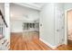 Open living room with hardwood floors, a fireplace, and adjacent rooms at 7605 Sandy Lake Ct, Raleigh, NC 27613