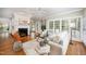 Cozy living room with a brick fireplace, neutral furnishings, and lots of natural light at 7605 Sandy Lake Ct, Raleigh, NC 27613