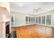 Bright and airy living room with hardwood floors, a fireplace, and large windows at 7605 Sandy Lake Ct, Raleigh, NC 27613