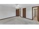 Bedroom with neutral carpet, two doors and view to bathroom at 8121 Bentwood Pl, Raleigh, NC 27615
