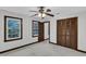Bedroom featuring a ceiling fan, two windows, neutral-toned walls, and wood trim at 8121 Bentwood Pl, Raleigh, NC 27615
