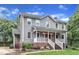 Charming two-story home with well-manicured lawn, landscaping, and a covered front porch with a brick stairway at 8121 Bentwood Pl, Raleigh, NC 27615