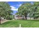 Charming gray two-story home with a well-manicured front yard and mature trees at 8121 Bentwood Pl, Raleigh, NC 27615