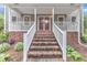Charming front porch with brick stairs and white railings lead to red double doors at 8121 Bentwood Pl, Raleigh, NC 27615
