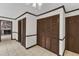 Hallway featuring tile flooring, closet doors, and view of living room with brick fireplace at 8121 Bentwood Pl, Raleigh, NC 27615