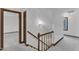 Carpeted hallway with wood railing at 8121 Bentwood Pl, Raleigh, NC 27615