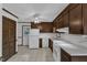 Spacious kitchen featuring white appliances, tiled flooring, and wood cabinetry at 8121 Bentwood Pl, Raleigh, NC 27615