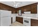 Kitchen showcasing white appliances and wood cabinets at 8121 Bentwood Pl, Raleigh, NC 27615