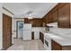 Traditional kitchen featuring wood cabinets, white appliances, and tiled floors at 8121 Bentwood Pl, Raleigh, NC 27615