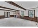 Bright, open living room with brick fireplace, wood beams, and natural light at 8121 Bentwood Pl, Raleigh, NC 27615