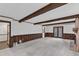 Open living room featuring brick fireplace, wood beams, and access to backyard at 8121 Bentwood Pl, Raleigh, NC 27615