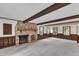 Spacious living room with brick fireplace, wood beams, and wainscoting at 8121 Bentwood Pl, Raleigh, NC 27615